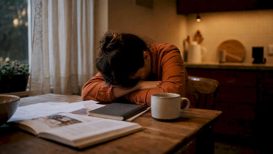 Weary professional woman at home office desk